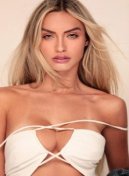 Liss, blonde Brazilian escort in London, in a white strappy top